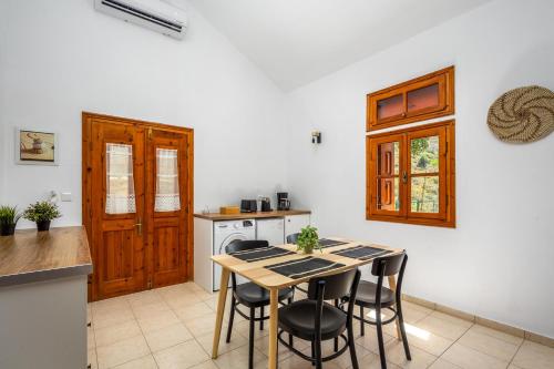 a kitchen with a table and chairs in a room at Nimporio View Villa in Symi