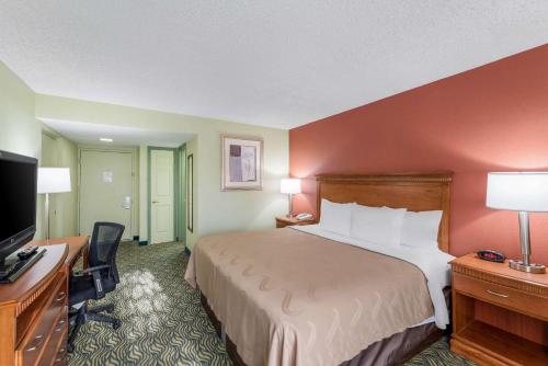 a hotel room with a bed and a flat screen tv at Quality Inn Payson in Payson
