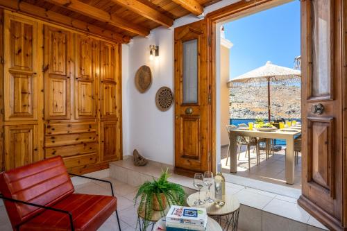 a living room with a red chair and a table at Nimporio View Villa in Symi