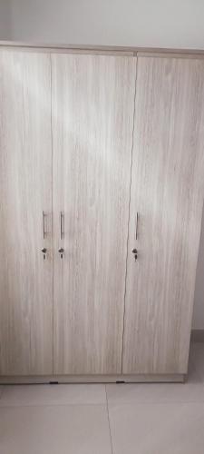 a pair of wooden cabinets in a room at Sweet Home ja-Ela in Ja-Ela