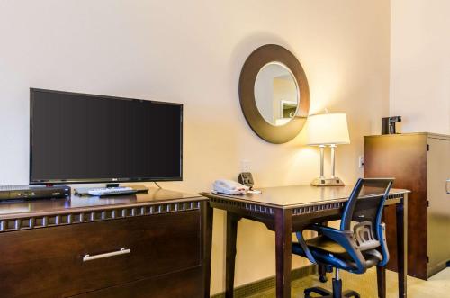 a room with a desk with a television and a chair at Comfort Suites in Gothenburg
