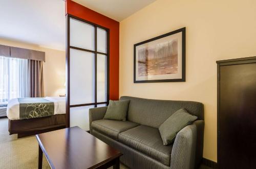 a living room with a couch and a bed at Comfort Suites in Gothenburg