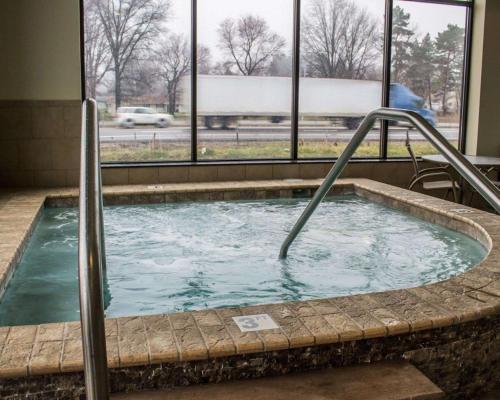 a jacuzzi tub in a room with a window at Comfort Inn & Suites Wadsworth in Wadsworth