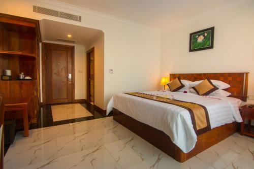 a bedroom with a large bed in a room at Glorious Hotel in Kompong Thom