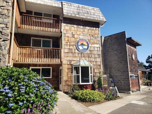 a building with a sign on the side of it at Beach Captain - Meredith Lodging in Neskowin
