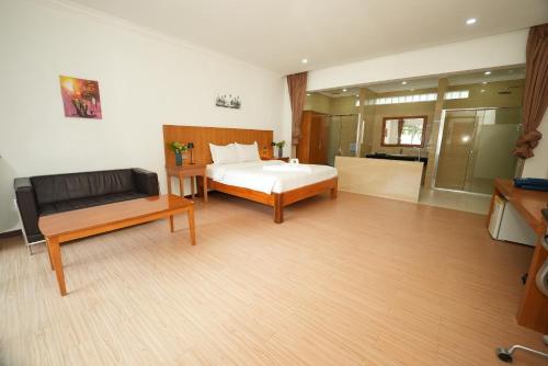 a bedroom with a bed and a couch in it at Amor Resort Koh Rong in Koh Rong Island