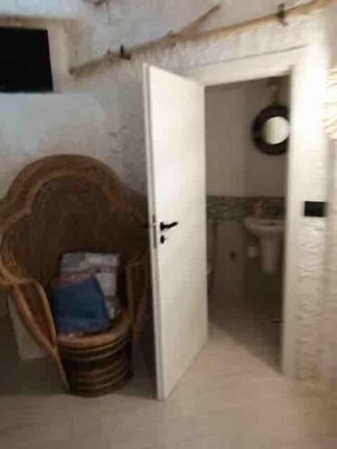 a bathroom with a door open and a toilet at Casa nella roccia in Ponza