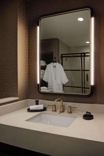 a bathroom with a sink and a mirror at Hotel Nickel Plate Fishers, Tapestry Collection By Hilton in Fishers