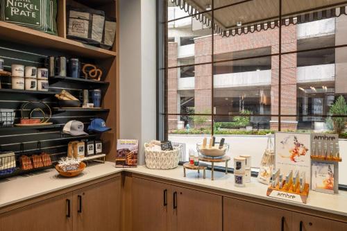 a shop with a counter with a window at Hotel Nickel Plate Fishers, Tapestry Collection By Hilton in Fishers