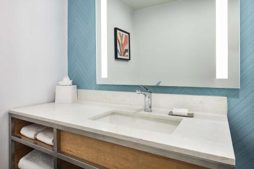 a bathroom with a sink and a mirror at Hilton Garden Inn Tewksbury Andover in Tewksbury