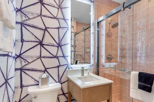 a bathroom with a toilet and a sink and a shower at The Mayfair Hotel Times Square, an Ascend Collection in New York