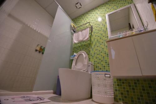 a bathroom with a toilet and a sink and a shower at Misto B&B in Taitung City