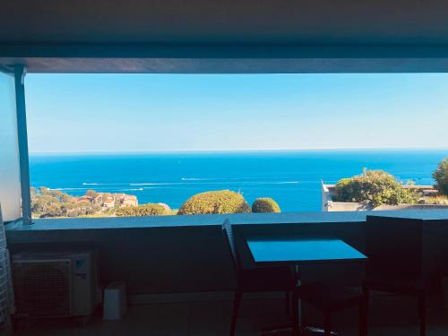a view of the ocean from a room with a window at Sunny Home Costa Plana-Monaco -Cap D'Ail in Cap d'Ail