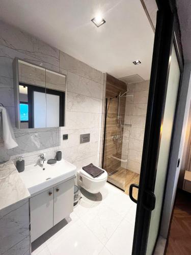 a bathroom with a toilet and a sink and a shower at Villa Zena Demre in Demre