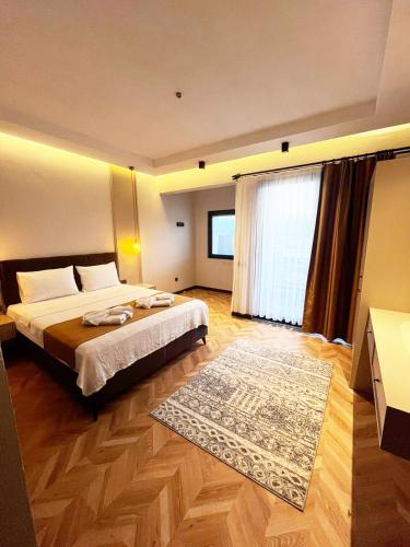 a hotel room with a bed and a large window at Villa Zena Demre in Demre