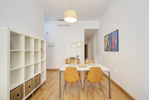 a dining room with a table and two chairs at Triana CACTUS in Melilla