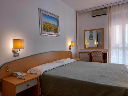 Postel nebo postele na pokoji v ubytování Hotel Nettuno