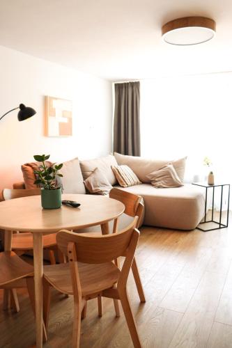a living room with a table and a couch at Beskid Balans & SPA in Krynica Zdrój