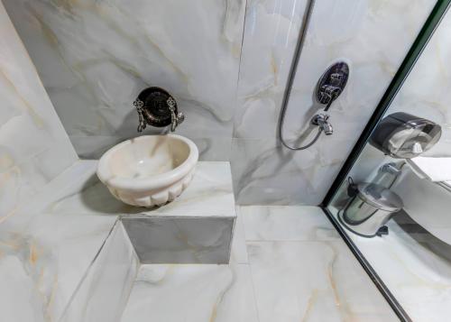 a white bathroom with a shower and a sink at Atar Airport Hotel - Spa & Wellness in Arnavutköy