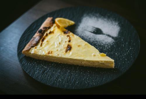 a piece of cheese on a plate with a face on it at Guesthouse Pri Tonetu in Ptuj