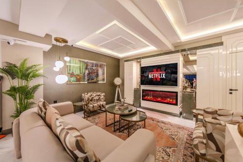 a living room with a couch and a tv at Atar Airport Hotel - Spa & Wellness in Arnavutköy