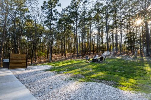 a group of people sitting on benches in a park at Coppermoon Cabin in Broken Bow
