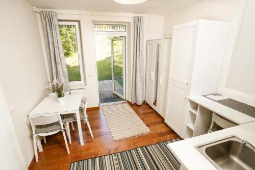 a kitchen and dining room with a table and chairs at Skalva Nida in Nida