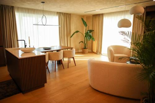 a living room with a couch and a table at Penthouse Lebada Lake View in Pantelimon