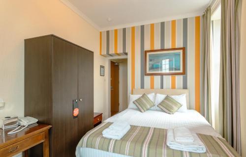a hotel room with a bed and a telephone at Gairloch Hotel 'A Bespoke Hotel' in Gairloch