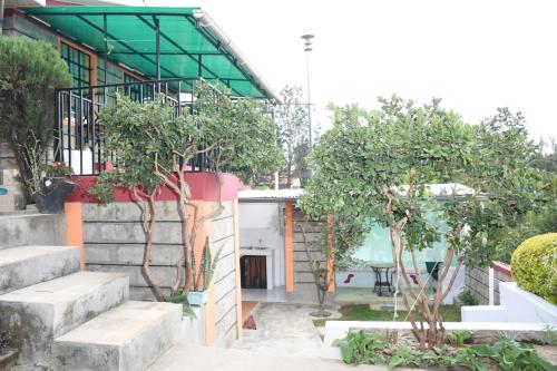 a building with trees and stairs in front of it at 1-bedroom serenity homes in Ongata Rongai 