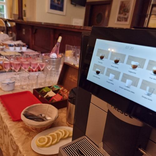 a laptop computer sitting on a table with food and drinks at Pałac Lucja BB in Zakrzów