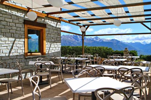 a patio with tables and chairs with mountains in the background at Hotel Chacaril in Pila