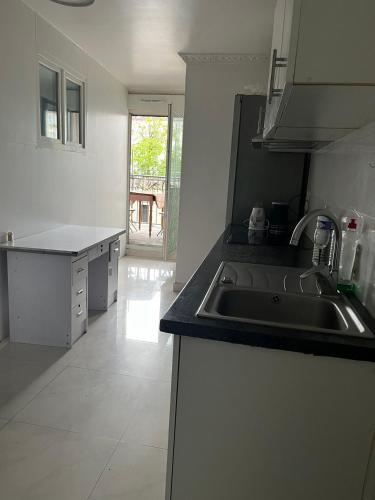 a kitchen with a sink and a counter top at 幸福小屋 in Pantin