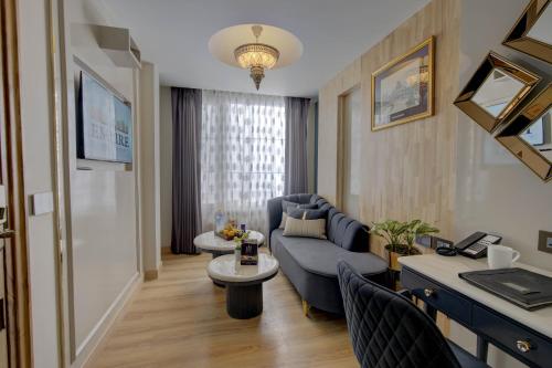 a living room with a couch and a table at Empire Platinum Suites in New Delhi