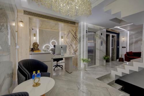 a lobby with a desk and a computer on a table at Empire Platinum Suites in New Delhi