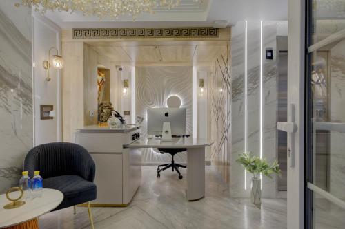 a room with a desk and a laptop on a table at Empire Platinum Suites in New Delhi