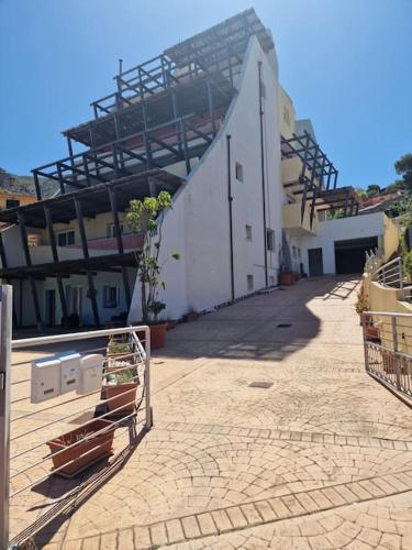 a building with a fence in front of it at Corallo Bilocale Vista Collina in Nebida