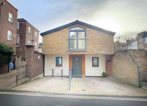 a brick house with a parking meter in front of it at 3 Bed House in central Richmond with driveway parking in Richmond