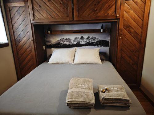 a bedroom with a bed with two towels on it at Peace & Rest in Pirineus in Latour-de-Carol
