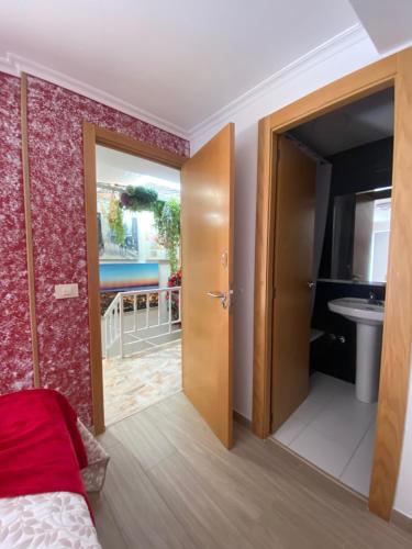 a bedroom with a door leading to a bathroom at Hostal la Colegiata in Vigo