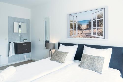 a bedroom with a bed with white sheets and a mirror at Prime Location Apt W Wifi & Near Poppodium 013 in Tilburg