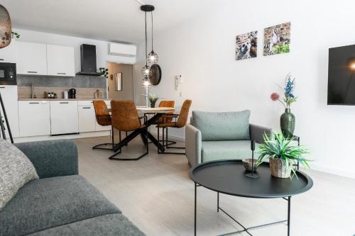 a living room with a couch and a table at Prime Location apt w wifi & near poppodium 013 in Tilburg