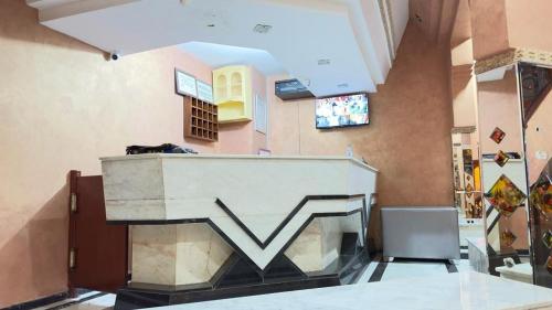 a room with a staircase in the middle of a building at HOTEL FADOUA in Moulay Yacoub