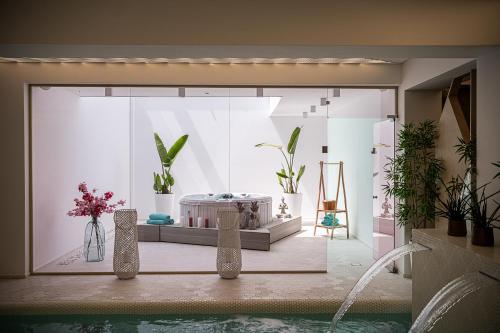 a room with potted plants in a room at Lagon Life Spirit Boutique Hotel - Adults Only in Chania Town