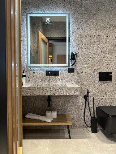 a bathroom with a sink and a mirror at Beliz Boutique Hotel in Vlorë