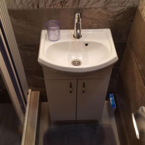 a white sink in a small bathroom at Apartment Marija in Risan