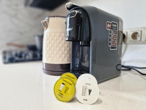 a coffee maker sitting next to a toaster on a counter at 5, 37, 65m2, Tashkent City Park, Boulevard in Tashkent
