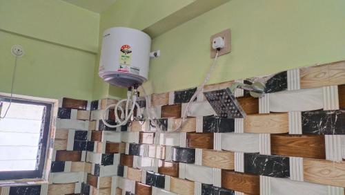 a room with a tile wall with a fire hydrant at Hotel Tulusi Inn ! Bolpur, Shantiniketan ! Luxury Feel In Budget in Bolpur