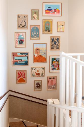a staircase with a wall of pictures on the wall at Hotel de Silhouette in Biarritz