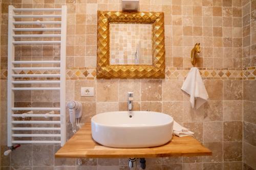 a bathroom with a white sink and a mirror at Vila Valeria in Techirghiol